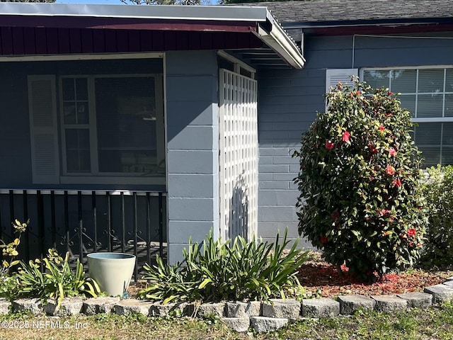 view of side of property featuring roof with shingles