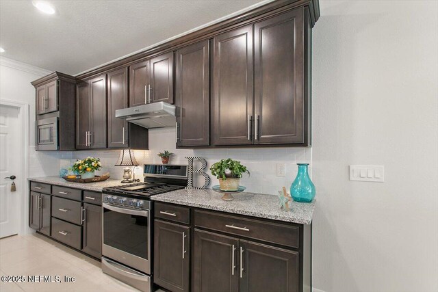 203 Country Brook Ave, Ponte Vedra, FL 32081 - kitchen with light stone countertops, stainless steel appliances, decorative backsplash, dark brown cabinetry, and under cabinet range hood