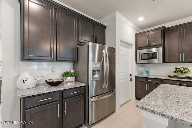 203 Country Brook Ave, Ponte Vedra, FL 32081 - kitchen with ornamental molding, tasteful backsplash, stainless steel appliances, light tile patterned flooring, and dark brown cabinets