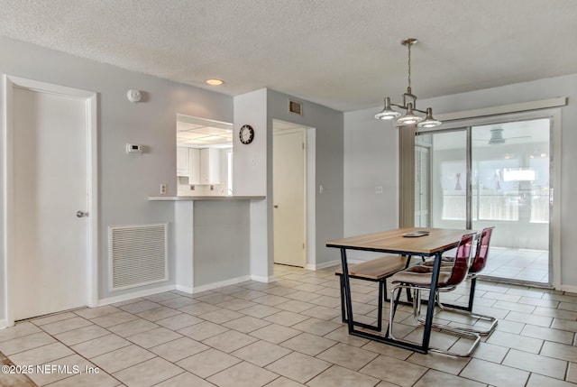 dining area featuring light tile patterned floors, visible vents, and baseboards