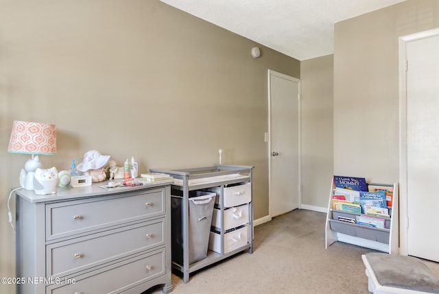 kitchen with light countertops, baseboards, gray cabinets, and light carpet