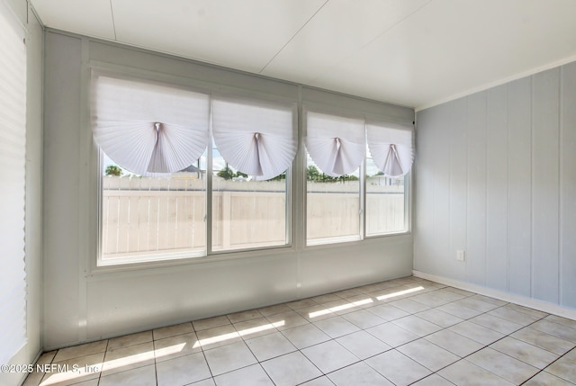 tiled spare room featuring a wealth of natural light