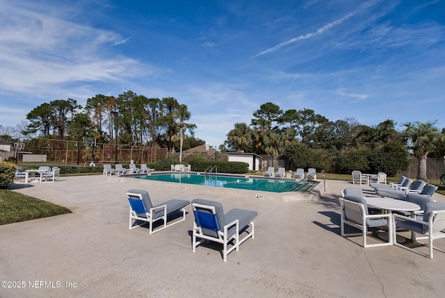 pool featuring a patio and fence