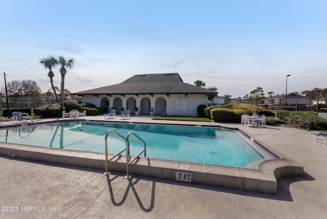 pool featuring a patio and fence