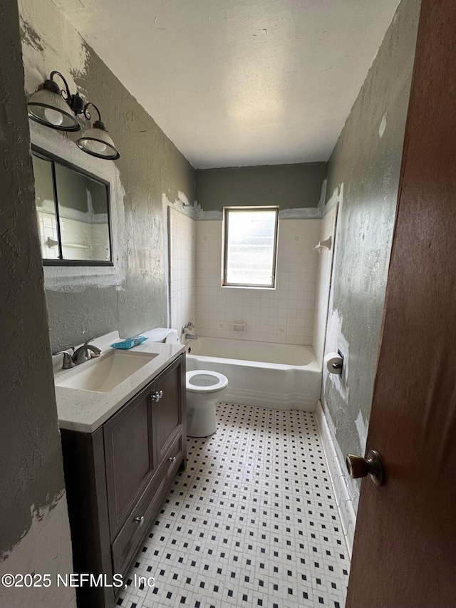 bathroom featuring vanity, shower / bath combination, tile patterned floors, toilet, and a textured wall