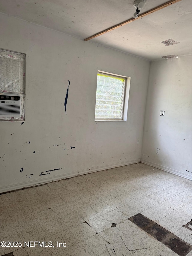 spare room with tile patterned floors, cooling unit, baseboards, and visible vents