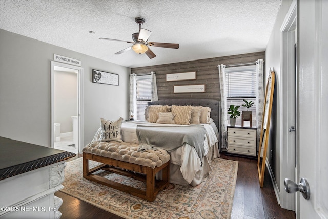 bedroom featuring multiple windows, a textured ceiling, and dark wood-style floors