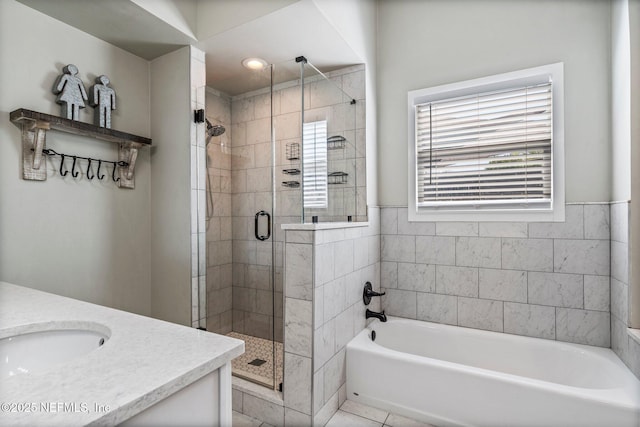 bathroom with tile patterned floors, vanity, a bath, and a shower stall