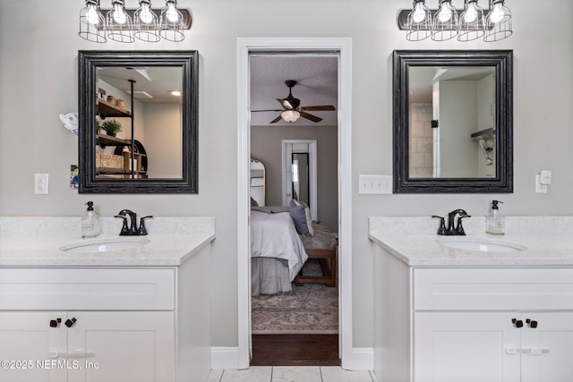 full bathroom with ensuite bath, two vanities, and a sink