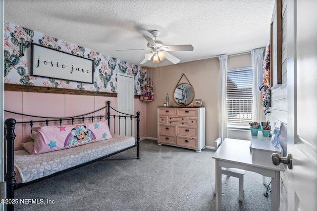 bedroom featuring baseboards, wallpapered walls, ceiling fan, a textured ceiling, and carpet flooring