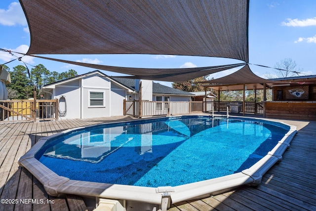 view of pool with a fenced in pool and a wooden deck