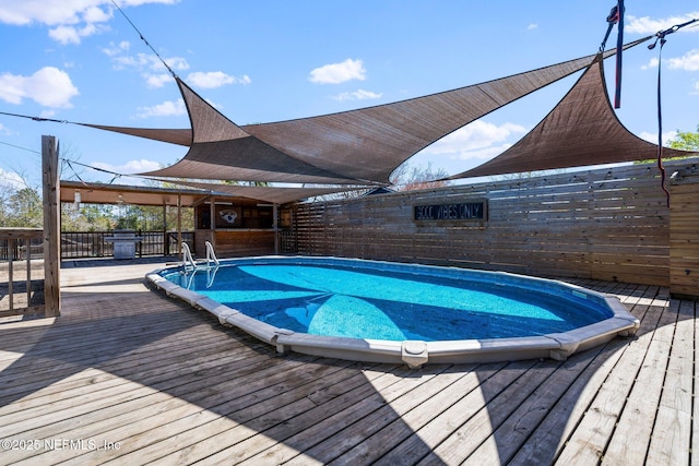 view of swimming pool featuring a deck