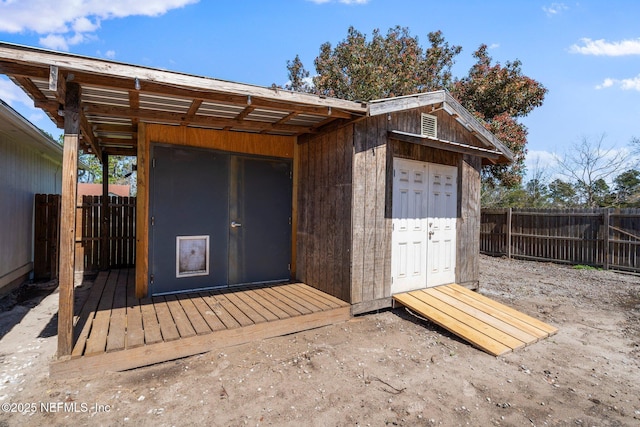 view of outdoor structure with fence