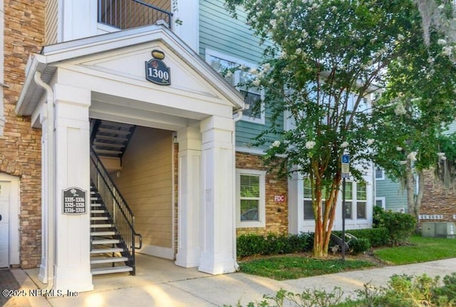 doorway to property featuring brick siding and a garage