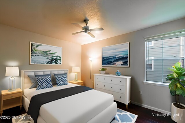 bedroom featuring baseboards, dark wood-style flooring, and ceiling fan