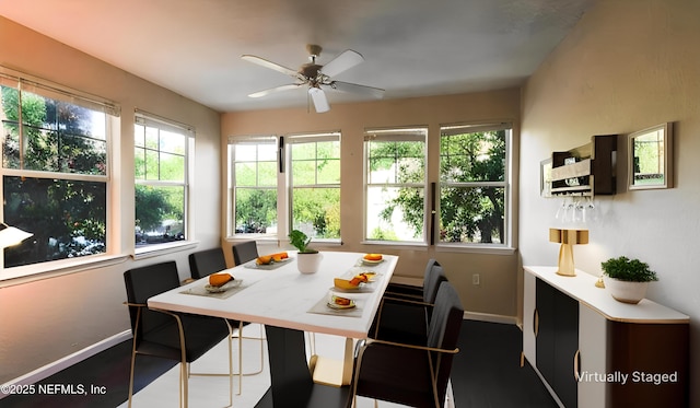 dining room with baseboards and ceiling fan