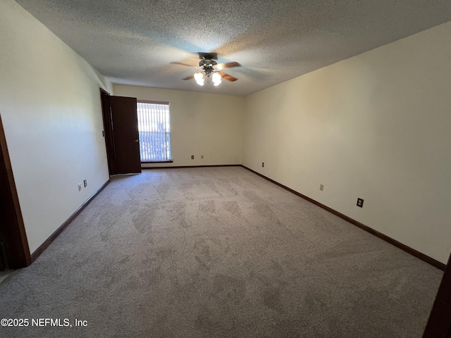 empty room with baseboards, light carpet, a textured ceiling, and ceiling fan