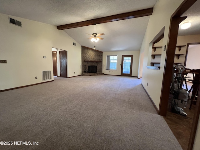 unfurnished living room featuring visible vents, a fireplace, a textured ceiling, and a ceiling fan