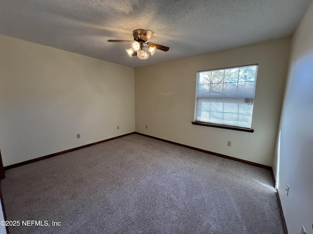 empty room featuring a textured ceiling, baseboards, ceiling fan, and carpet floors