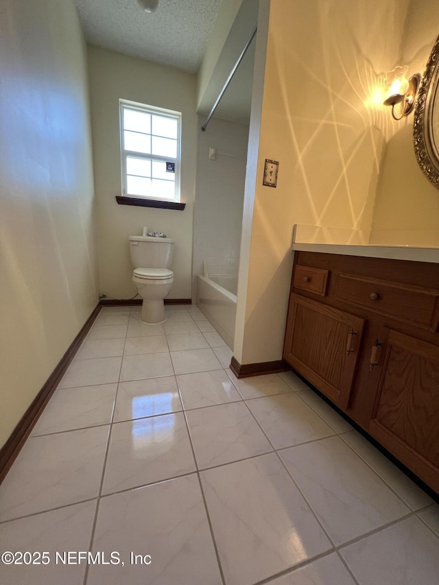 full bath featuring vanity, toilet, baseboards, and a textured ceiling