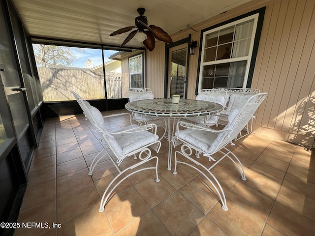 sunroom featuring a ceiling fan