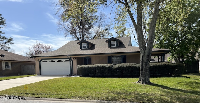 view of front facade featuring a shingled roof, concrete driveway, a garage, and a front lawn