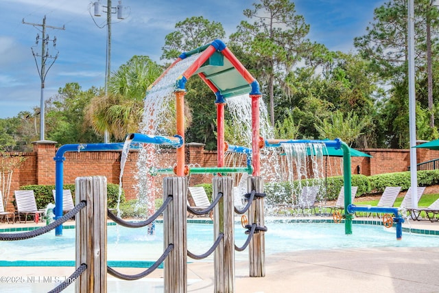 view of playground featuring fence