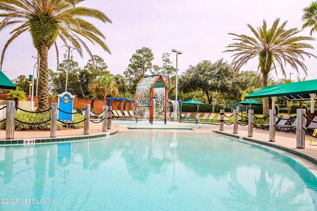 community pool with playground community and fence