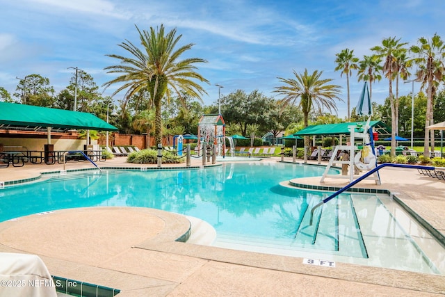 pool with a patio and fence