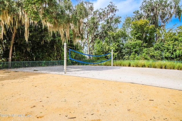 surrounding community featuring fence and volleyball court