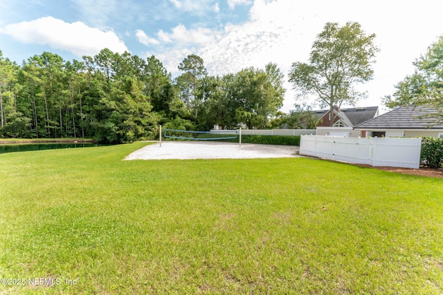 view of yard with volleyball court and fence