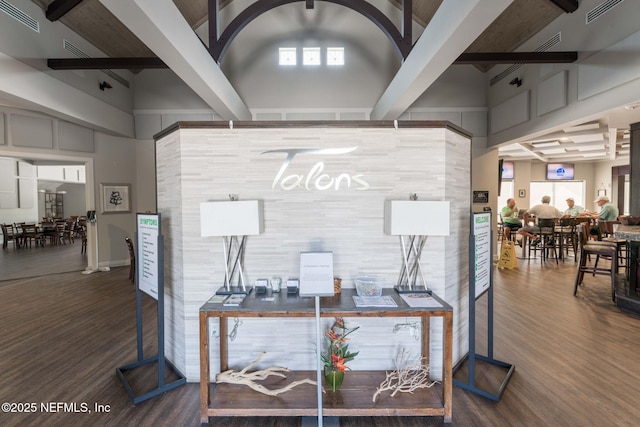 office space featuring beamed ceiling, visible vents, and wood finished floors