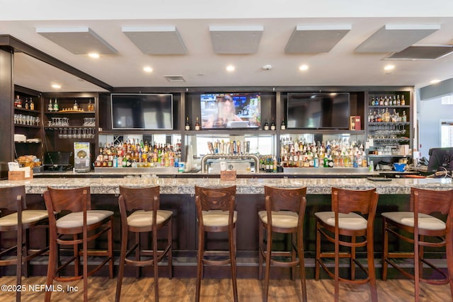 bar featuring wet bar and wood finished floors