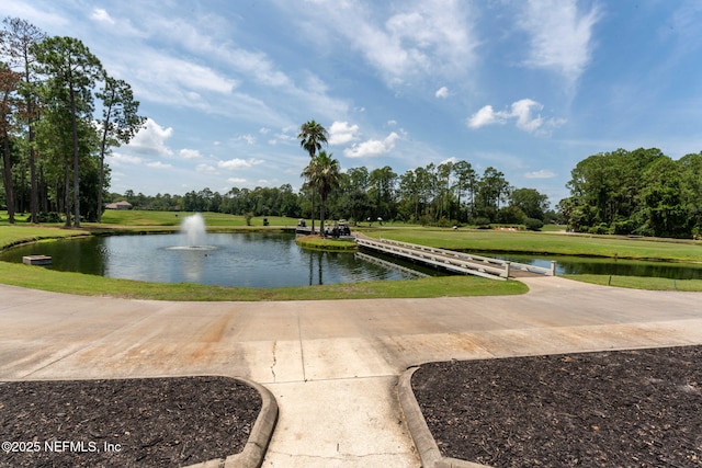 exterior space with a lawn and a water view