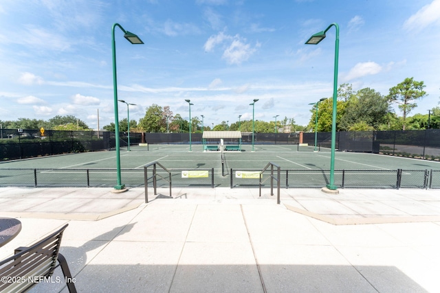 view of tennis court with fence