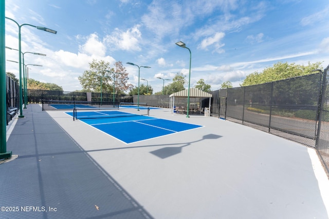 view of sport court featuring fence