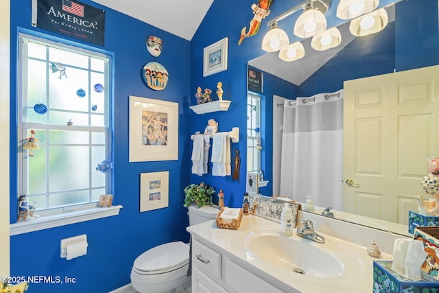 bathroom featuring curtained shower, toilet, vanity, and lofted ceiling