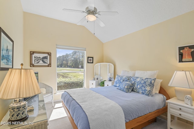 bedroom with a ceiling fan, vaulted ceiling, and carpet