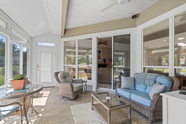 sunroom / solarium featuring lofted ceiling with beams and ceiling fan