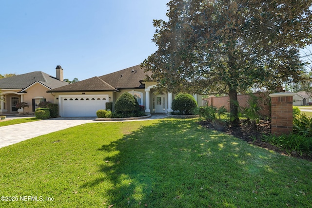 view of front of home featuring a front yard, driveway, an attached garage, a chimney, and stucco siding