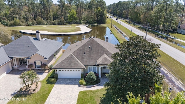 birds eye view of property with a water view