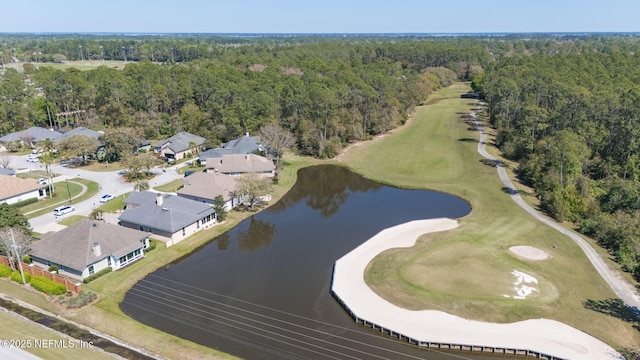 aerial view featuring a forest view and a water view