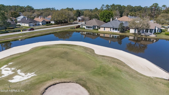 drone / aerial view featuring a residential view and a water view