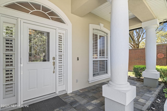 entrance to property with stucco siding