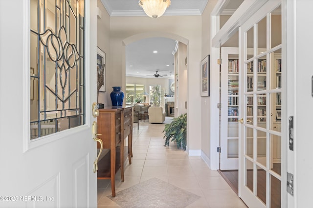 entryway featuring crown molding, ceiling fan, light tile patterned floors, recessed lighting, and arched walkways