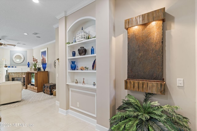 corridor with visible vents, recessed lighting, built in shelves, and ornamental molding