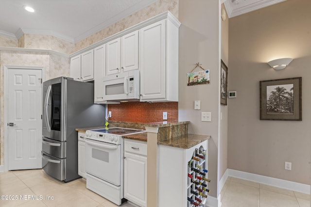 kitchen featuring tasteful backsplash, crown molding, light tile patterned flooring, white appliances, and white cabinetry