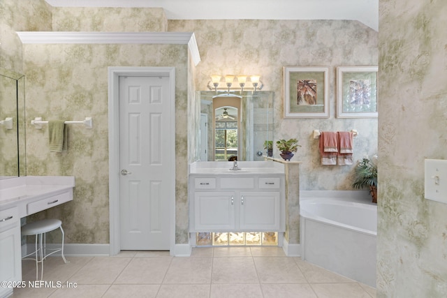 bathroom featuring vanity, baseboards, wallpapered walls, tile patterned flooring, and a garden tub