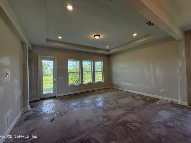 286 Lamego Ln, Saint Augustine, FL 32095 - spare room with unfinished concrete flooring, a raised ceiling, and recessed lighting