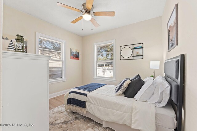 4517 Delta Ave, Jacksonville, FL 32205 - bedroom featuring multiple windows, wood finished floors, and a ceiling fan